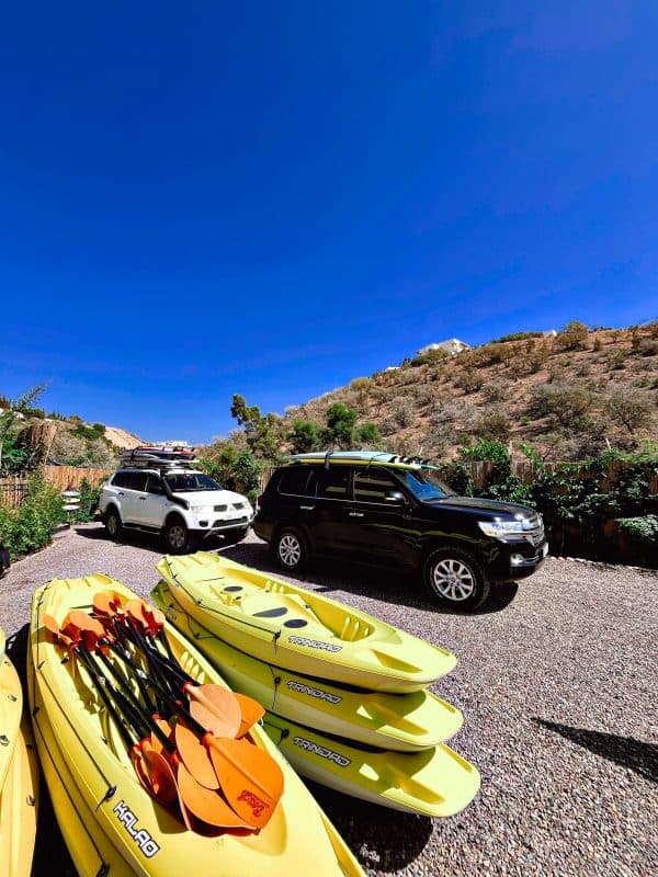 Kayaks and vans parked in the lodge garden