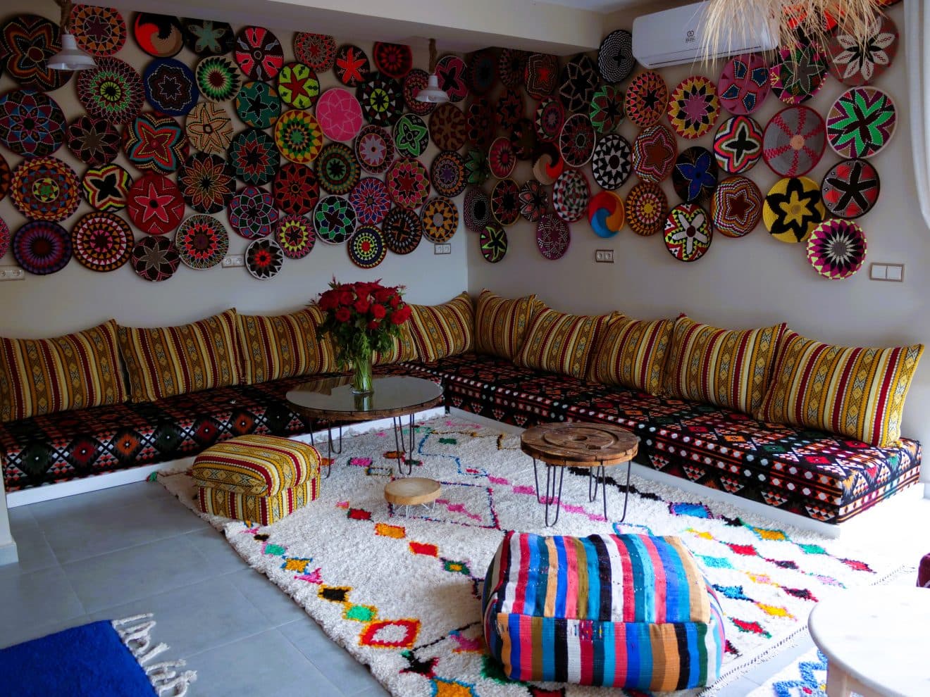 A Moroccan lounge with woven plates and low seating
