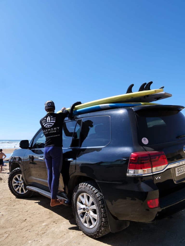 Loading surfboards onto the roof of the van